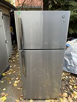 Exterior front view of stainless steel refrigerator with top freezer