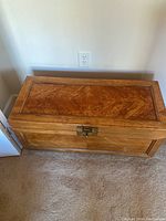 Top angle photo of wooden chest showing surface and wood grain detail