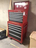 Full view of red two-piece Craftsman tool chest stacked in basement
