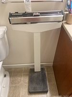 Full view of the Health-o-meter doctor's scale showing the base, metal stand, and weighing mechanism with weight sliders.