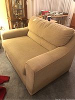 Front and left side view of beige La-Z-Boy loveseat showing seat and back cushions, armrest detail.