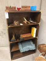 Full view of wooden shelving unit displaying all items
