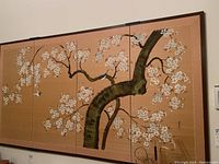 Full view of the framed silk art featuring cherry blossoms and a blue bird on tree branches.