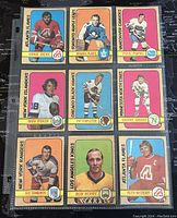 Front side of 9 assorted 1972-3 O-Pee-Chee NHL player cards showing various teams and players in colored border designs.