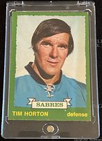 Front image of the 1973-74 O-Pee-Chee Tim Horton Buffalo Sabres trading card, showing player portrait and team name with green border.