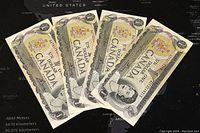 Four 1973 Canadian one dollar banknotes fanned out showing front design with Queen Elizabeth II portrait and Canadian coat of arms.