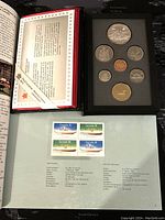 Open presentation of the 1989 Canadian proof coin set showing 8 coins in black foam insert and red booklet with text inside.