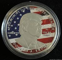 Front side showing colored American flag and profile of Donald J. Trump with inscriptions