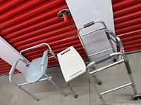 Image of an assisted toilet seat alongside an adjustable bath seat with side handles, showing cleanliness and good repair.