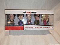 Front view of sealed box showing five bobble-heads