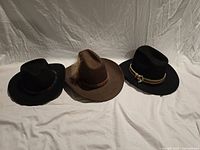All three cowboy hats side by side on white backdrop