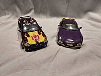 Black Honda Civic and purple convertible die-cast cars front view