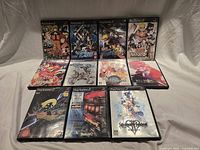 All ten PS2 game cases displayed, four standing and six lying flat