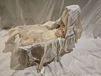 Doll in cradle full view