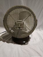 Front view of Seabreeze fan showing wire mesh cage and label