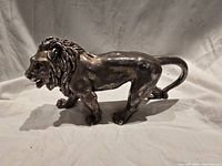 Front and side view of sterling silver lion figurine