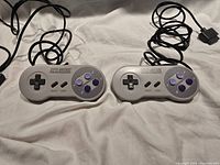 Both SNES controllers front view with cords visible