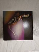 Front cover with eye and tear artwork