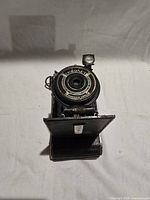 Front view of Coronet folding camera with bellows extended and viewfinder raised