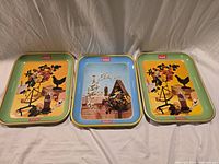 Three Coca-Cola trays side by side