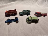 All five diecast vehicles displayed on cloth background