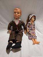 Both dolls side by side showing relative sizes and outfits