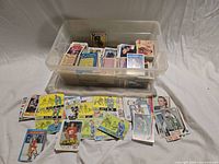 Overall view of bin filled with hockey cards and several cards spread out