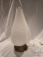 Front view of tulip lamp showing white petal shade and base