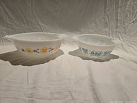 Both Pyrex bowls side by side showing size difference and patterns