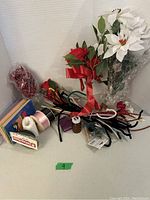 Photo showing artificial flowers, ribbons, pipe cleaners, craft wire, and foam sheets in craft box