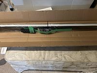 Full length packaged LED linear light showing protective wrapping and tags