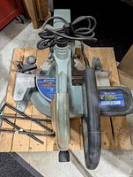 Top view of saw showing handle, power cord, and part of sliding rail.