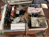 Overhead shot showing Leica M3, flashes, tripod, light meter, film boxes, cables and caps