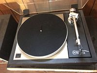 Top-down view of turntable showing platter, felt mat, tonearm and dust cover