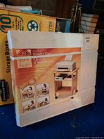Photo of unopened folding printer cart box showing product image and packaging.