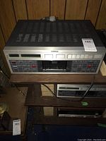 Front view of first unit on wooden shelf with MaxSold tag