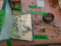 Overall lot including floral necklace, three pairs of clip-on earrings, link chain necklace and bracelet, ring and tortoiseshell bangle