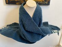 Full length of the blue-grey alpaca scarf arranged on a display bust showing texture and size.