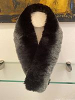 Full view of the chinchilla fur collar displayed on a mannequin, showing the black center with pale grey edges.