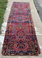 Full length view of Persian Sarouk Lilihan runner rug laid on sidewalk