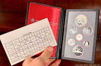 Open leather case holding 1983 Canadian proof coins and an information/specifications card.