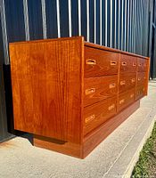 Left side perspective showing full length, plinth base and recessed handles.