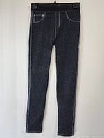 Full view of dark grey women's pants with elastic waistband hanging on a black hanger, showing overall look and fit.