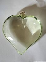 Clear glass or crystal heart-shaped pendant with metal bail viewed from front.