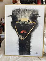 Front view of framed ostrich artwork showing full animal portrait in a gold frame.