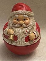 Front view of the vintage Santa Claus wind-up musical toy showing Santa holding a bell and a candy cane.