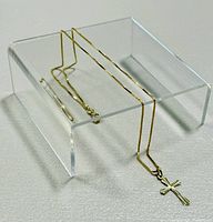 Full view of 14K yellow gold box chain and cross pendant displayed on acrylic stand