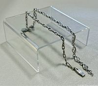 Two 7.5 inch 925 sterling silver bracelets displayed on clear stand showing chain styles and clasps