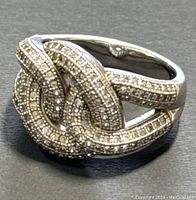 Close-up of 925 silver ring showing knot design with marcasite stones