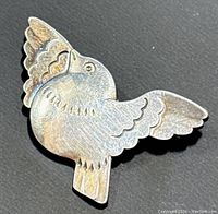 Top-side view of brooch on dark surface